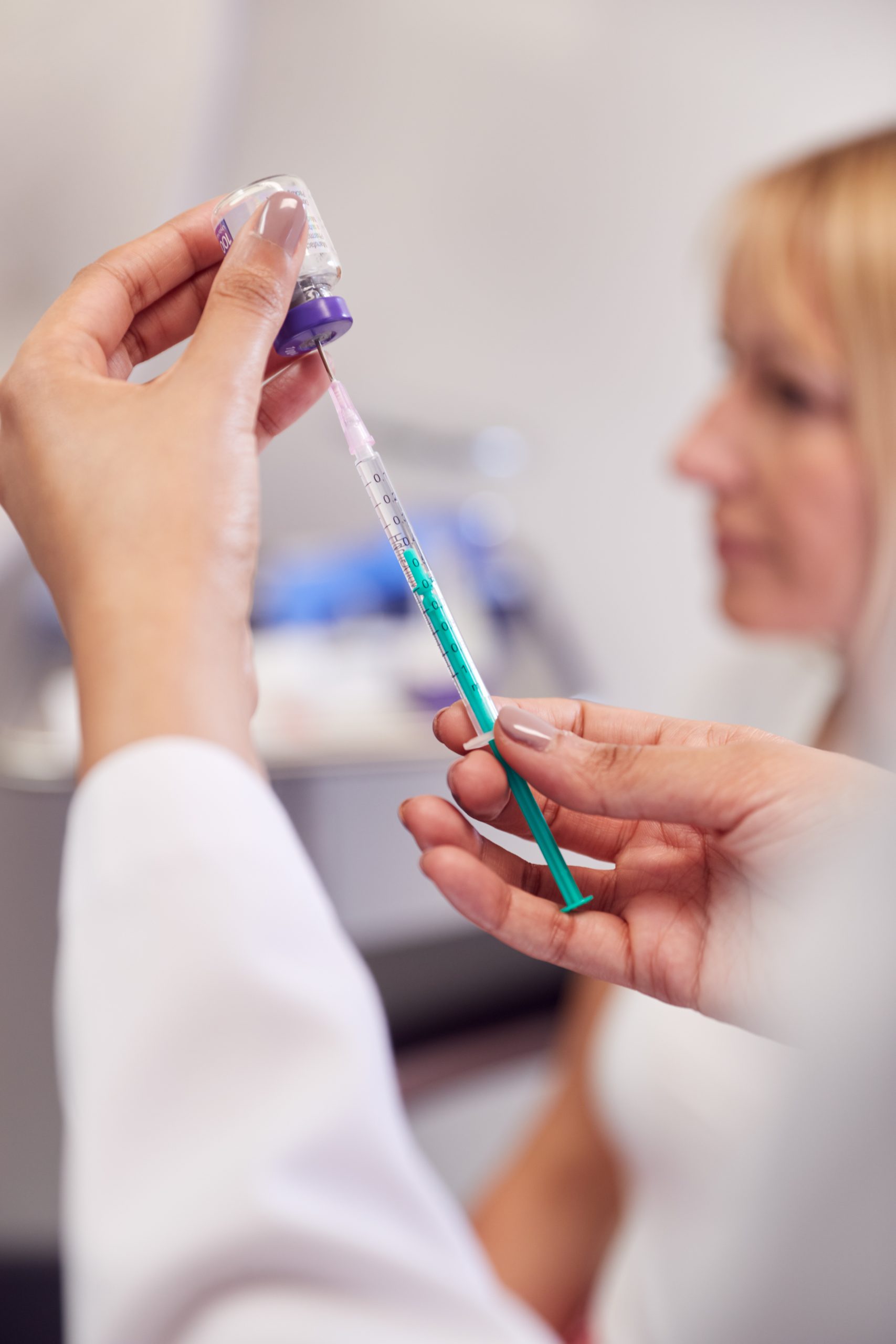 Close Up Of Beautician Filling Syringe Ready For Botox Injection